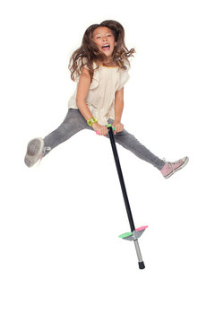 Miley a young girl jumping on a pogo stick on May 1 2010. Stock Photo Adobe Stock