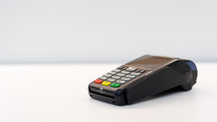 close up soft focus credit card reader  machine at white background table for  business financial about contactless payment concept