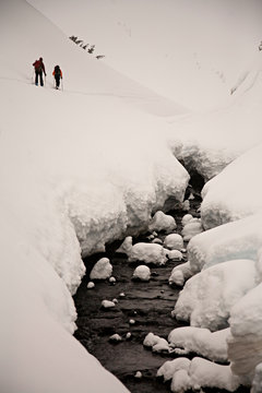 Two female skiers climb in the backcountry towards Herman Saddle near Mount Baker.