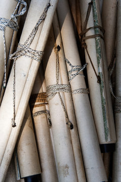 Close-up of scrolls fastened with twine.