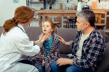 Pleasant nice man touching his daughters shoulder