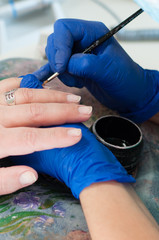 Manicure, extension and cleaning of nails in a beauty salon. Beauty services concept