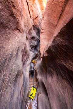 Eric Odenthal canyoneering and wading in Neon canyon, Grand Staircase Escalante-National Monument, Utah.
