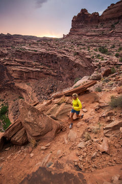 Heidi Rentz running on the Hunters Canyon Rim Trail, Moab, Utah.