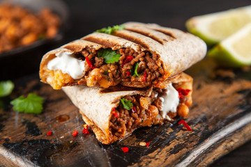 Mexican burrito with beef, beans and sour cream - 257477148