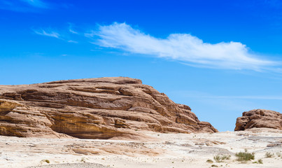 Fototapeta premium high rocky mountains against the blue sky and white clouds in the desert in Egypt Dahab South Sinai