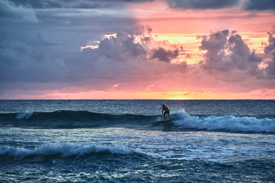 Surfer at sunset in Rincon, Puerto Rico