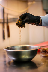 The chef cooking chicken wings in a sauce in the kitchen. Decorating the dishes with colored blobs. Lymon. Chicken. Sauce with honey and seasonings