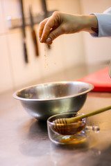 The chef cooking chicken wings in a sauce in the kitchen. Decorating the dishes with colored blobs. Lymon. Chicken. Sauce with honey and seasonings