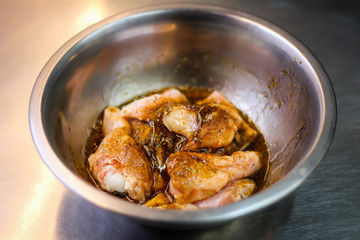 The chef cooking chicken wings in a sauce in the kitchen. Decorating the dishes with colored blobs. Lymon. Chicken. Sauce with honey and seasonings
