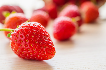 Fresh organic red ripe Strawberry fruit on wood background closeup