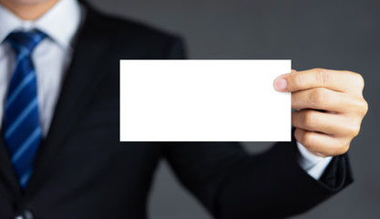 Businessman holding blank advertisement card with copy space.