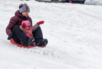 Mother and Daughter sledging in Quebec