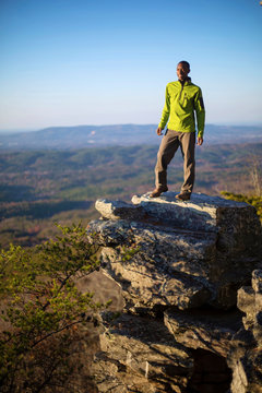 Young Man Stands On Boulder On Edge Of Mount Cheaha, USA