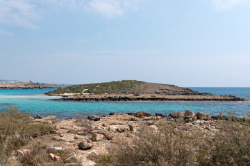 Naklejka na ściany i meble Crystal clear waters and sandstone rocks of the Mediterranean Sea, Cyprus. Tropical sea bay landscape, beach coastline