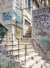 stairs between buildings with graffiti