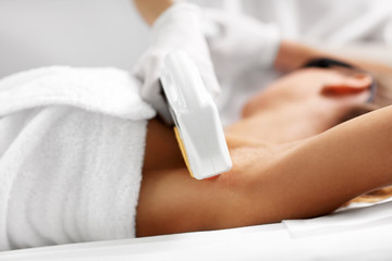 Fototapeta premium Beautician Giving Epilation Laser Treatment To Woman On Armpits