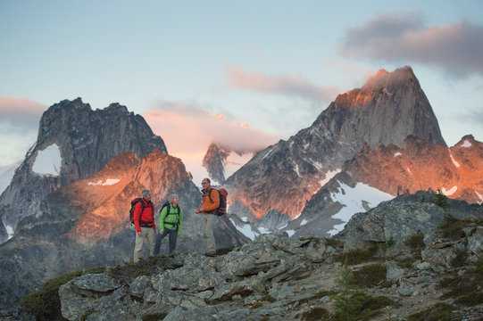 Hikers talking with their guide at sunrise.