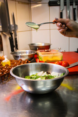 Chef cooking Caesar salad. Poached egg. Green. Sadat, Cheri tomatoes. Chestnut sauce. Decoration of plates. Fried bacon