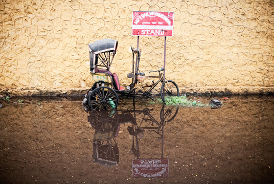 A Broken Tuc Tuc Sits In A Puddle Of Water In Chennai, India.