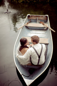 Bride and Groom in a row boat.