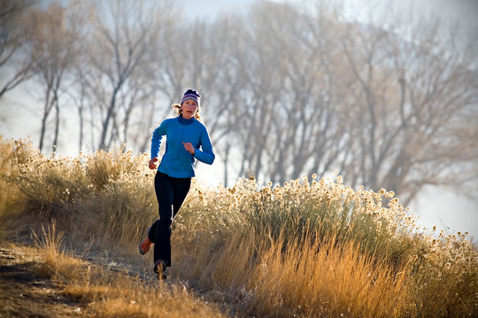 Brooke Haverstock trail running at sunrise on the sage lined trails outside of Bishop, California