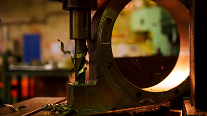 Construction plant. A machine drilling a hole in the iron detail