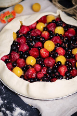 homemade puff pastry pie with cherry plums, blueberries and strawberries