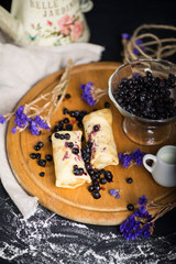 sweet pancakes with blueberry jam and berry jam in a glass vase
