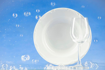 A plate and a glass on a blue background