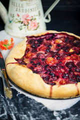 homemade puff pastry pie with cherry plums, blueberries and strawberries