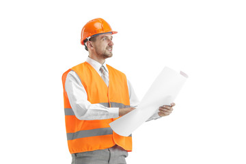 The builder in a construction vest and orange helmet standing on white studio background. Safety specialist, engineer, industry, architecture, manager, occupation, businessman, job concept