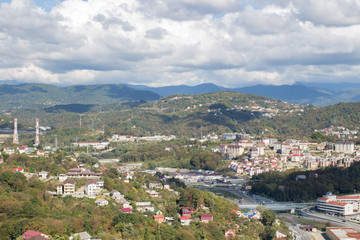 Fototapeta na wymiar Panorama of the city by the mountains in summer