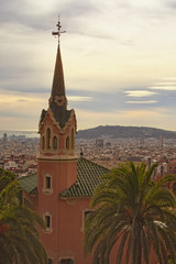 Stunning house with tower in Park Guell in cloudy day. Famous touristic place and travel destination in Barcelona, Spain, Europe