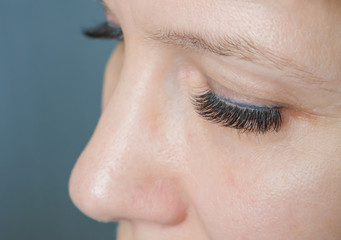 Eyelash extension. A woman's eye with lashes.