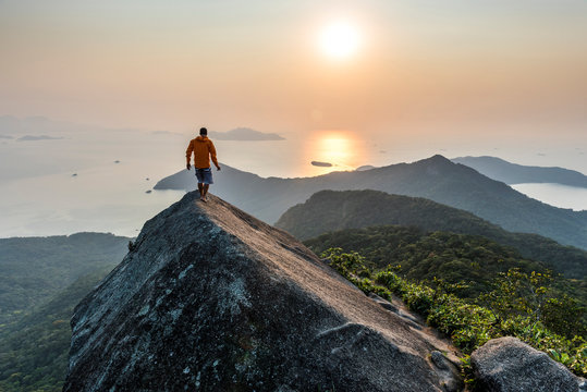 Man trekking on top of Ilha Grande at sunrise