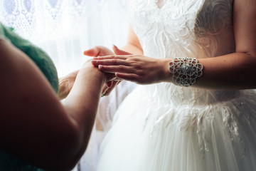 morning of the bride, a beautiful woman in a white dress is preparing for the wedding