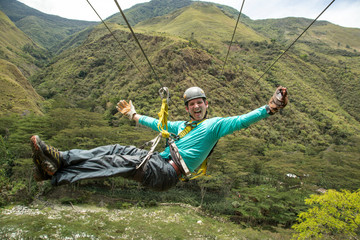 Man riding on zipline through Amazon forest, Santa Teresa, Cusco region, Peru