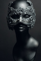 Black head of mannequin in creative metal mask with jewels