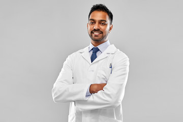 medicine, science and profession concept - smiling indian male doctor or scientist in white coat over grey background - obrazy, fototapety, plakaty
