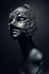 Black head of mannequin in creative metal mask with jewels