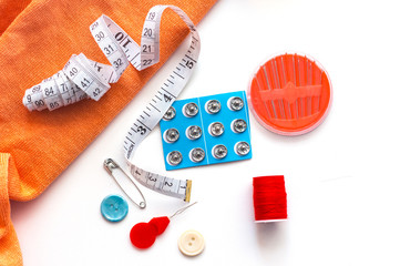 sewing accessories on white background, flat lay copy space