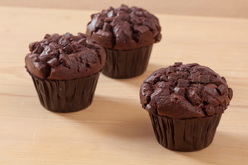 Homemade cake chocolate muffin on wooden background close-up