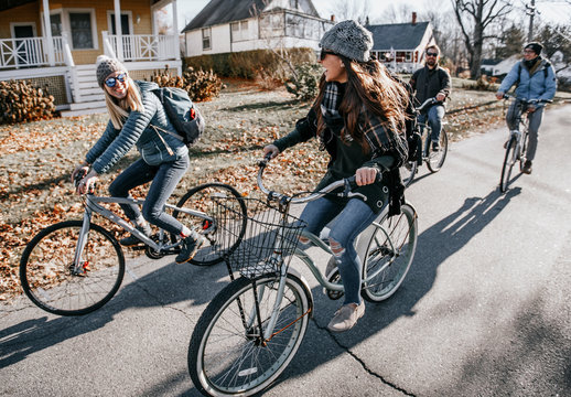 Group of friends biking through village in autumn, Portland, Maine, USA