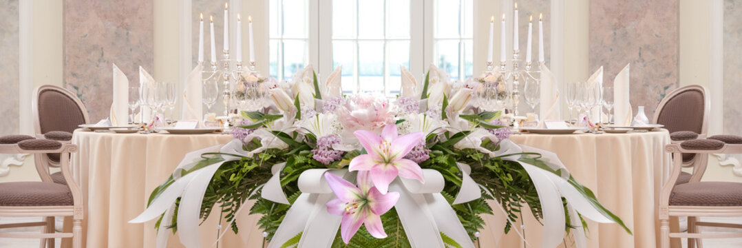 Festive Covering Table With Candles And Flowers In The Foreground