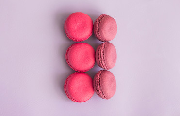 Multicolored macaroons on a gently lilac background
