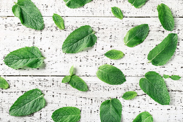 Mint leafs on white wooden table