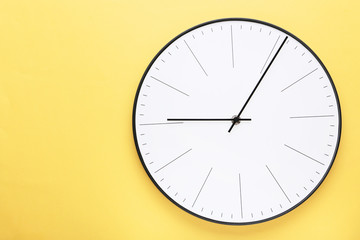 Round clock on yellow background