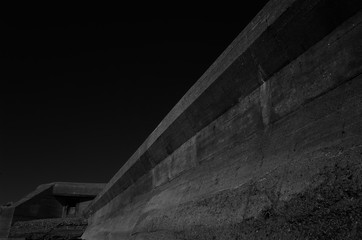 Anti-tank wall and bunker, Jersey, U.K. B&W image of WW2 brutalist architecture.