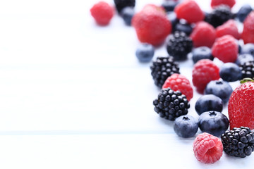 Ripe and sweet fruits on white wooden table